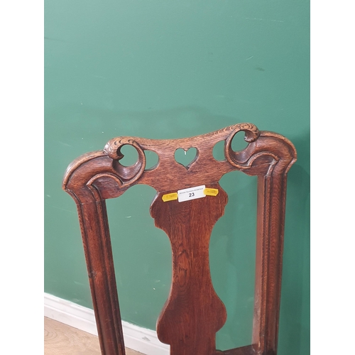 23 - An oak Side Chair with carved and pierced top rail, shaped splatback with solid seat on turned front... 