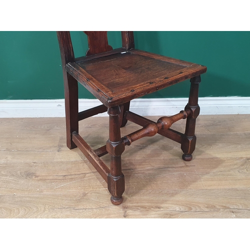 23 - An oak Side Chair with carved and pierced top rail, shaped splatback with solid seat on turned front... 