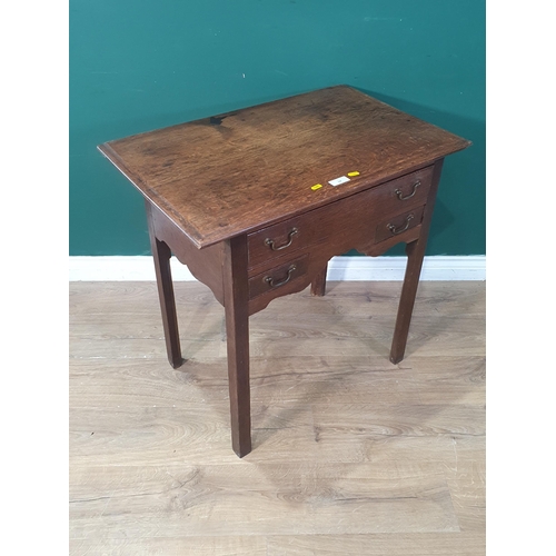 24 - A Georgian oak Lowboy with moulded top and fitted three drawers around a shaped frieze and raised on... 