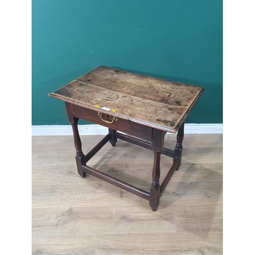 27 - An Early 18th Century oak Side Table with single fitted drawer, raised on turned supports united by ... 