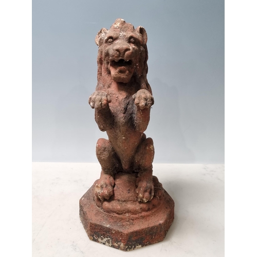 4 - A cast iron Seated Lion with octagonal base and rope twist style decoration, 14