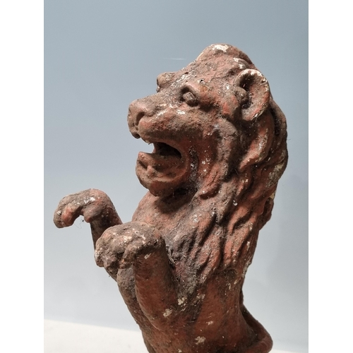 4 - A cast iron Seated Lion with octagonal base and rope twist style decoration, 14