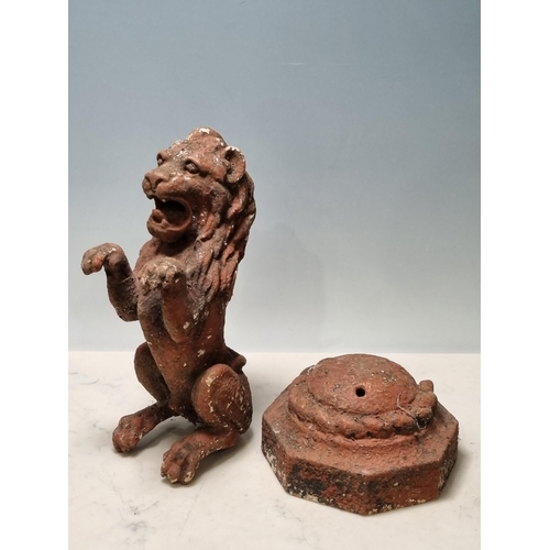 4 - A cast iron Seated Lion with octagonal base and rope twist style decoration, 14