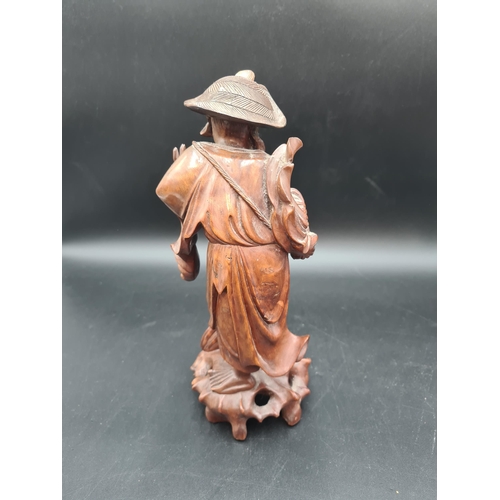 51 - A carved Oriental wooden Figure of bearded gent feeding bird, 12in (R1)