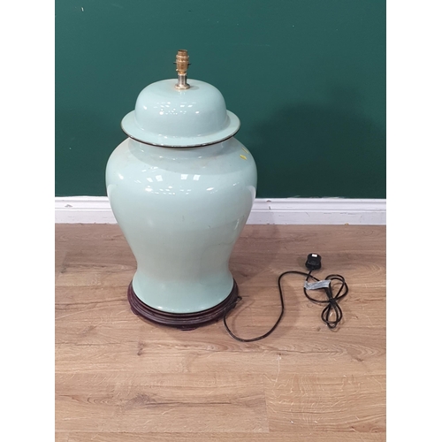 671 - A large celadon green Table Lamp on circular turned hardwood base, 2ft 5