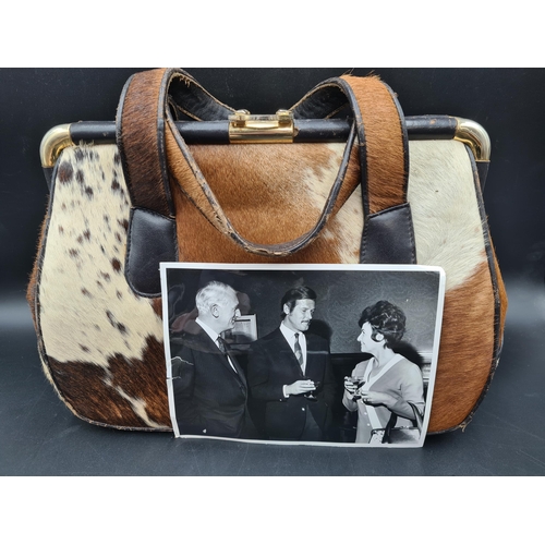 71 - An African skin covered Handbag, with photograph of owner, and an Osprey by Graeme Ellison, London, ... 