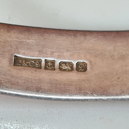 91 - An Elizabeth II silver Slave Bangle with thistle engraving and gold rosettes, Birmingham 1978