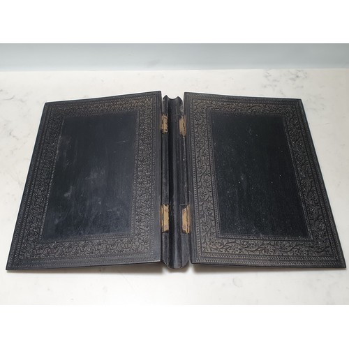 67 - An Indian ebonised hardwood Book Cover with all over carved floral decorations. (R2).