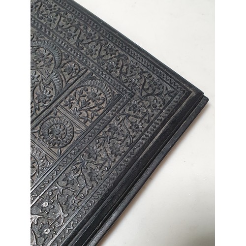 67 - An Indian ebonised hardwood Book Cover with all over carved floral decorations. (R2).