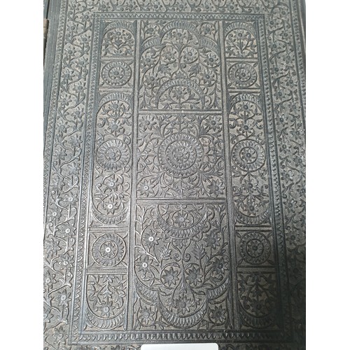 67 - An Indian ebonised hardwood Book Cover with all over carved floral decorations. (R2).