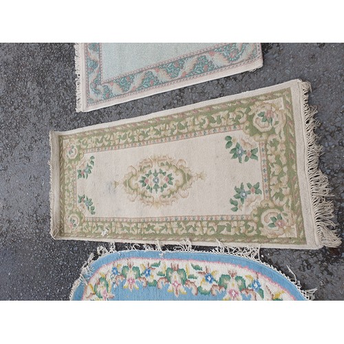 258 - A Chinese style blue ground oval Rug, a small Runner with green and floral designs and a small fring... 