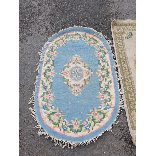 258 - A Chinese style blue ground oval Rug, a small Runner with green and floral designs and a small fring... 