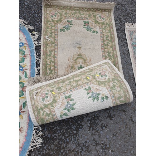 258 - A Chinese style blue ground oval Rug, a small Runner with green and floral designs and a small fring... 