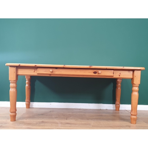 478 - A modern pine Kitchen Table with single fitted drawer raised on turned supports, 30