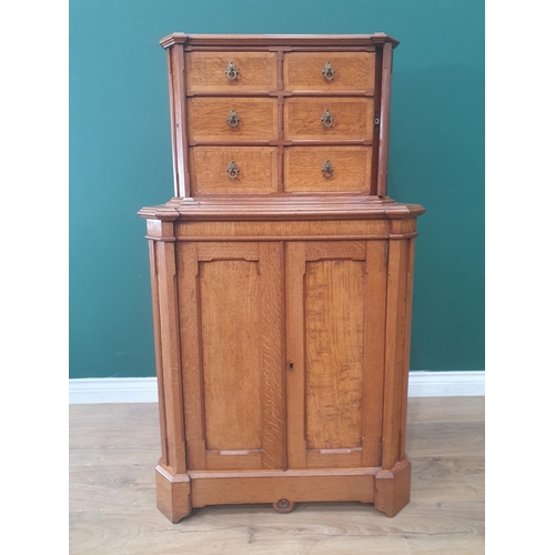 An Aesthetic movement oak with chamfered corners, the upper