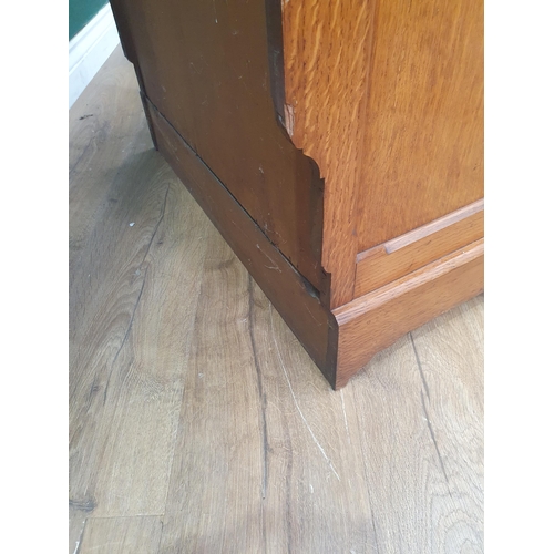 An Aesthetic movement oak with chamfered corners, the upper