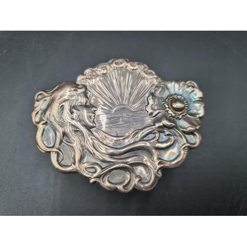 102 - An Edward VII Art Nouveau silver shaped oval Trinket Box with figure, flower and sunburst embossing,... 