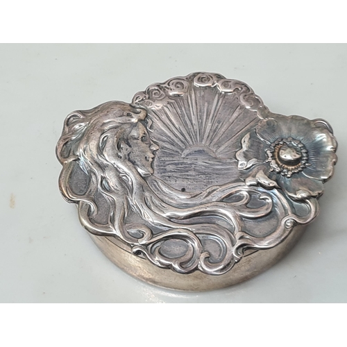 102 - An Edward VII Art Nouveau silver shaped oval Trinket Box with figure, flower and sunburst embossing,... 