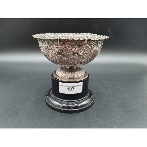 107 - A Victorian silver Bowl with floral and leafage scroll embossing, London 1882, A/F on plinth