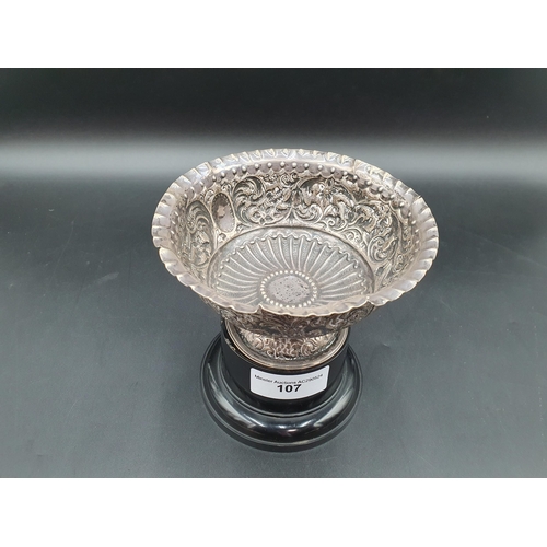 107 - A Victorian silver Bowl with floral and leafage scroll embossing, London 1882, A/F on plinth