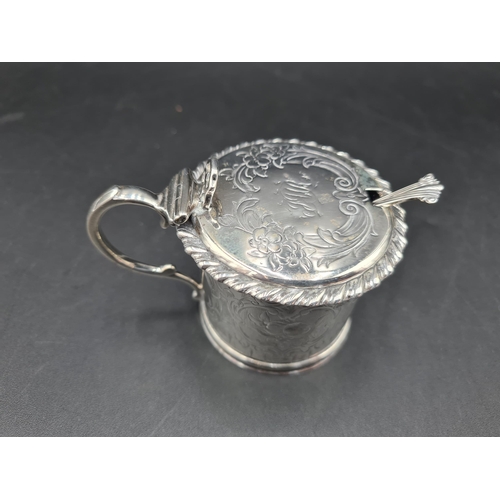 130 - A Victorian silver Drum Mustard Pot with gadroon rim, floral and scroll engraved, blue glass liner, ... 