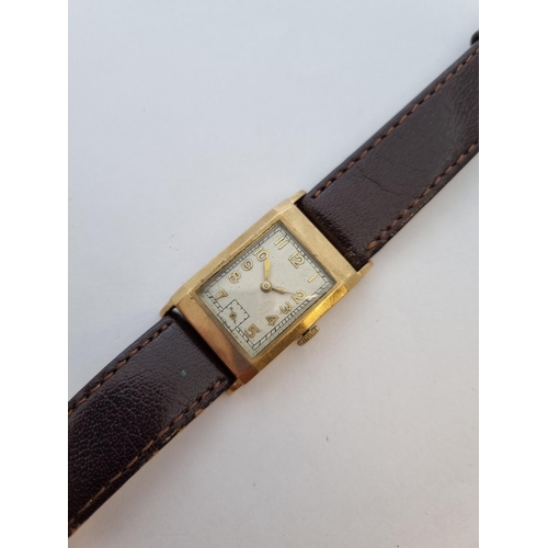 157 - A 1930's manual wind rectangular Wristwatch the cream dial with gold arabic numerals and subsidiary ... 