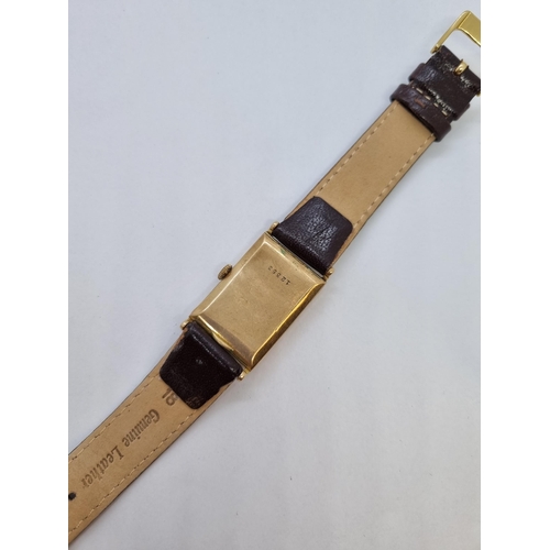 157 - A 1930's manual wind rectangular Wristwatch the cream dial with gold arabic numerals and subsidiary ... 