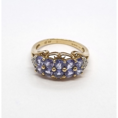 164 - A Tanzanite and Diamond Ring peg-set two rows of tanzanites and four brilliant-cut diamonds on eithe... 