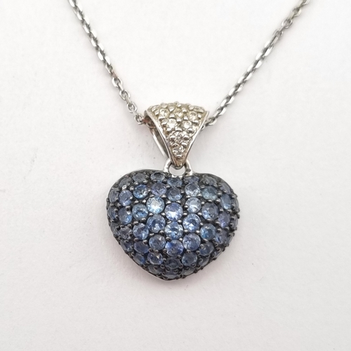 197 - A heart shaped Pendant peg-set numerous round blue topaz bale set diamonds on fine chain in 18ct whi... 