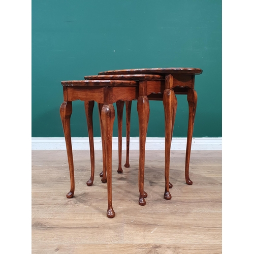 24 - A walnut veneered Nest of three Tables 1ft 10in W x 1ft 10in H (R6)