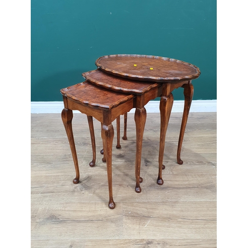 24 - A walnut veneered Nest of three Tables 1ft 10in W x 1ft 10in H (R6)