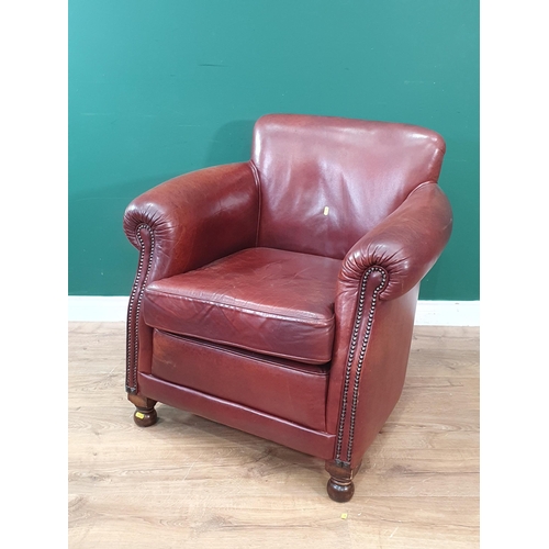 25 - A brown leather Armchair on turned feet 2ft 8in H x 2ft 8in W (R6)