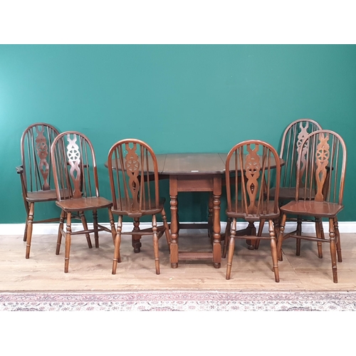 27 - An old Charm oak Gateleg Table 3ft 1in W x 2ft 5in H and a set of six wheelback Kitchen Chairs (R7)