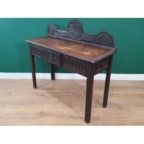 28 - An antique oak Side Table with raised back and carved frieze fitted end drawer A/F 3ft 6in W x 3ft 1... 