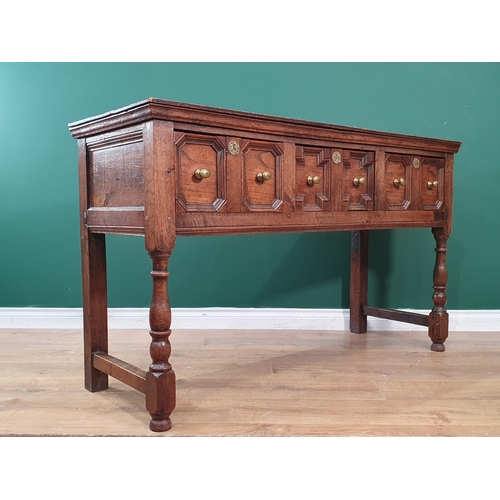 30 - An oak Dresser Base in the 17th Century style fitted three moulded drawers raised on turned supports... 