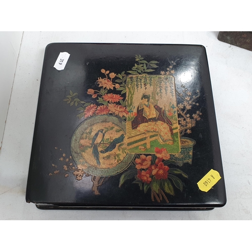 319 - A Japanese Album containing photographs and postcards, a Japanese black lacquered papier mache Box a... 