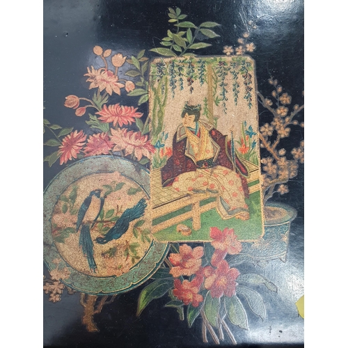 319 - A Japanese Album containing photographs and postcards, a Japanese black lacquered papier mache Box a... 