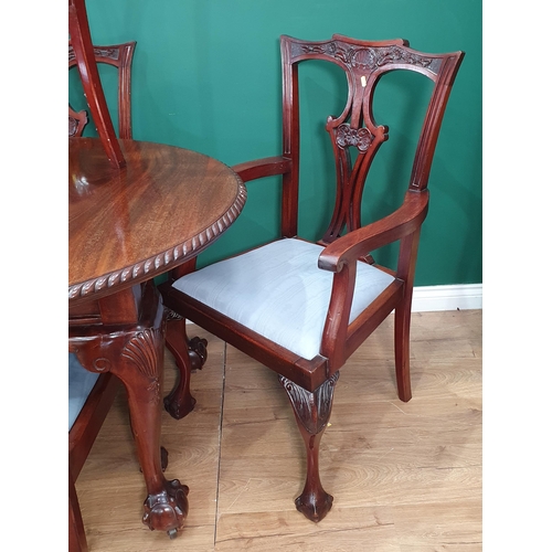 35 - A Georgian style mahogany Extending Dining Table on shell carved cabriole supports with two spare le... 