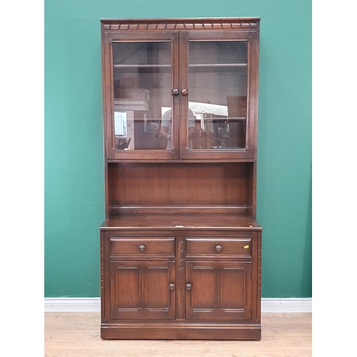 45 - An Ercol Dresser with glazed upper section above base fitted two drawers over pair of cupboard doors... 