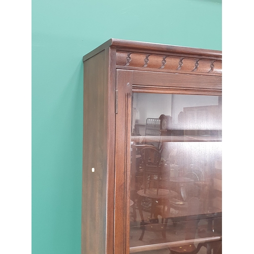 45 - An Ercol Dresser with glazed upper section above base fitted two drawers over pair of cupboard doors... 