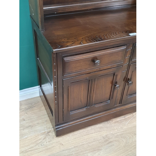 45 - An Ercol Dresser with glazed upper section above base fitted two drawers over pair of cupboard doors... 