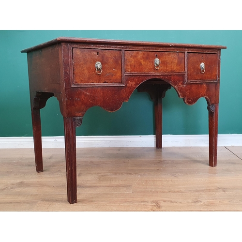 456 - A Mahogany table with shaped front fitted three drawers with lion mask ring pull handles raised on s... 