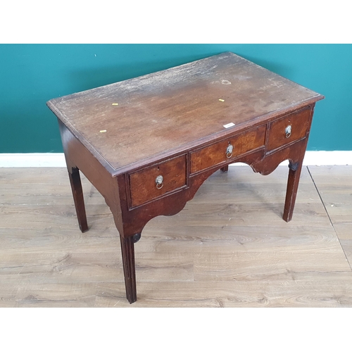 456 - A Mahogany table with shaped front fitted three drawers with lion mask ring pull handles raised on s... 