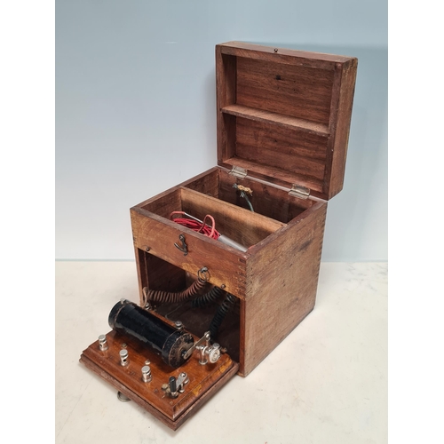 60 - A wooden cased Tens Machine? bearing small makers plate for 