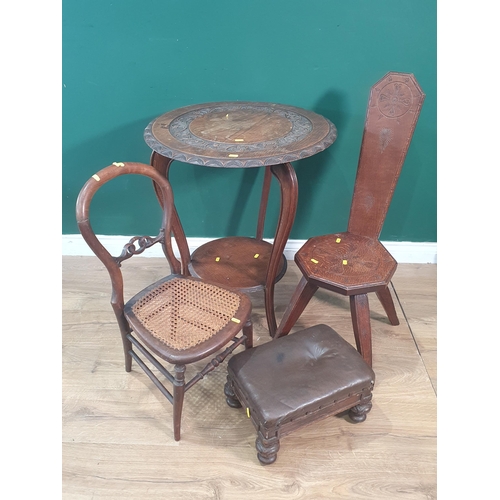 608 - An oak two tier Occasional Table, the circular top with carved scroll and leafage designs raised on ... 