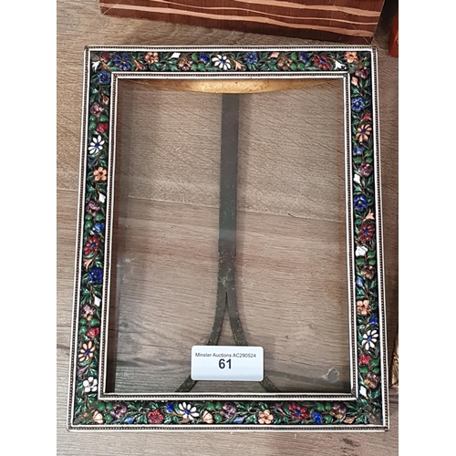 61 - An enamel decorated easel Photograph Frame with multi coloured floral decorations, a gilt metal Phot... 