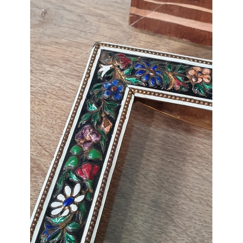 61 - An enamel decorated easel Photograph Frame with multi coloured floral decorations, a gilt metal Phot... 