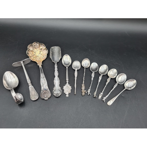 75 - A sterling silver Cheese Scoop, six Continental silver Spoons, isle of Man Souvenir Spoon, Coffee Sp... 