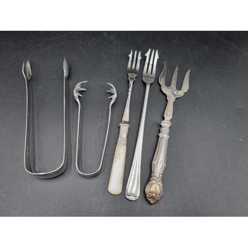 79 - A pair of George III silver Sugar Tongs, London 1812, pair of Ice Claws, Sheffield 1904, two Pickle ... 