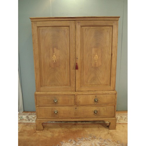 106 - A Georgian mahogany and vase inlaid Linen Press fitted pair of cupboard doors above base fitted two ... 